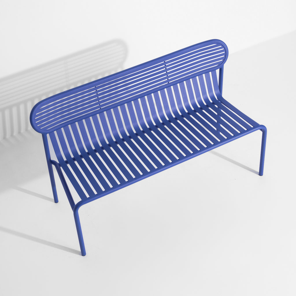 Blue metal slatted outdoor bench with curved back, minimalist frame