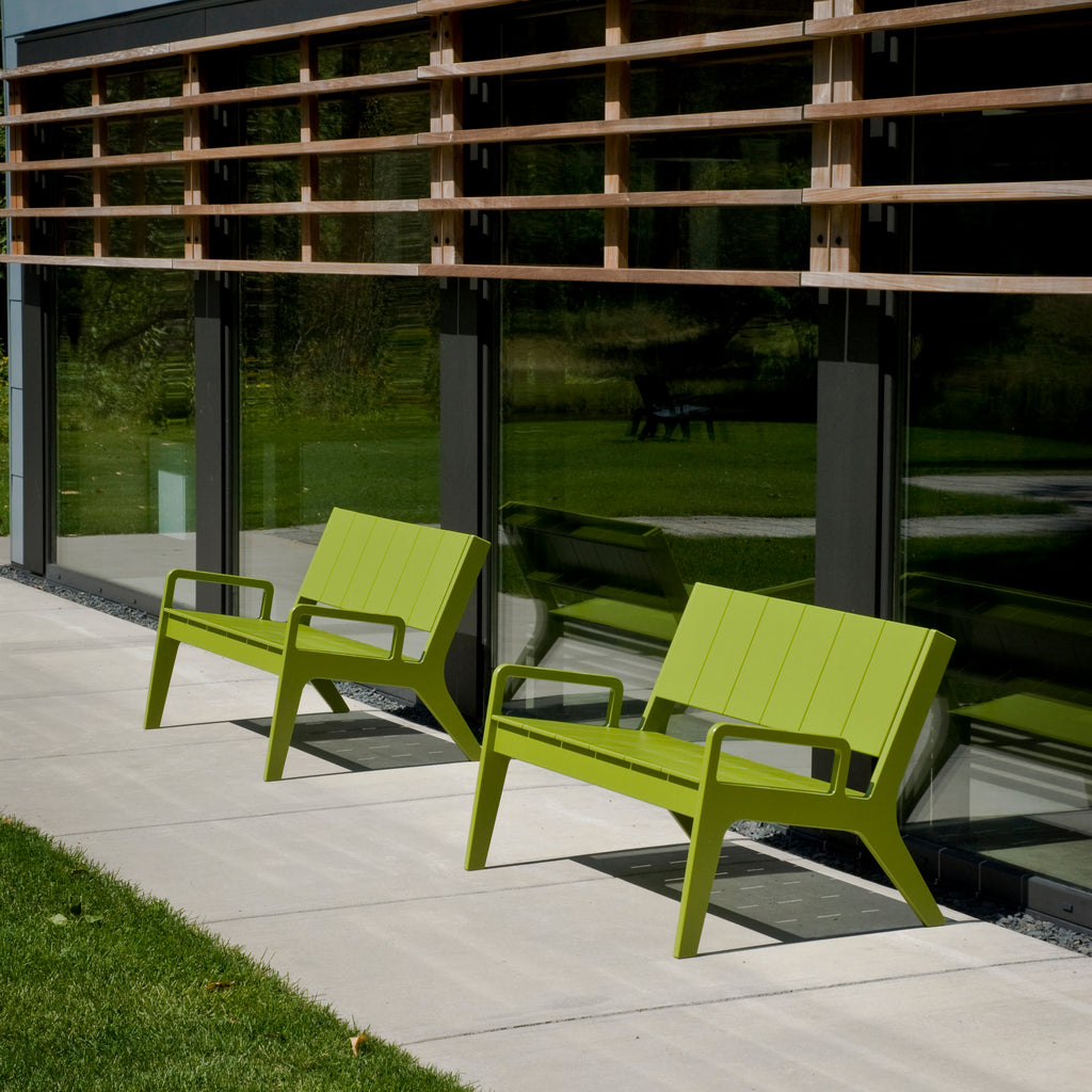Outdoor seating area with lime green chairs and blue table on patio